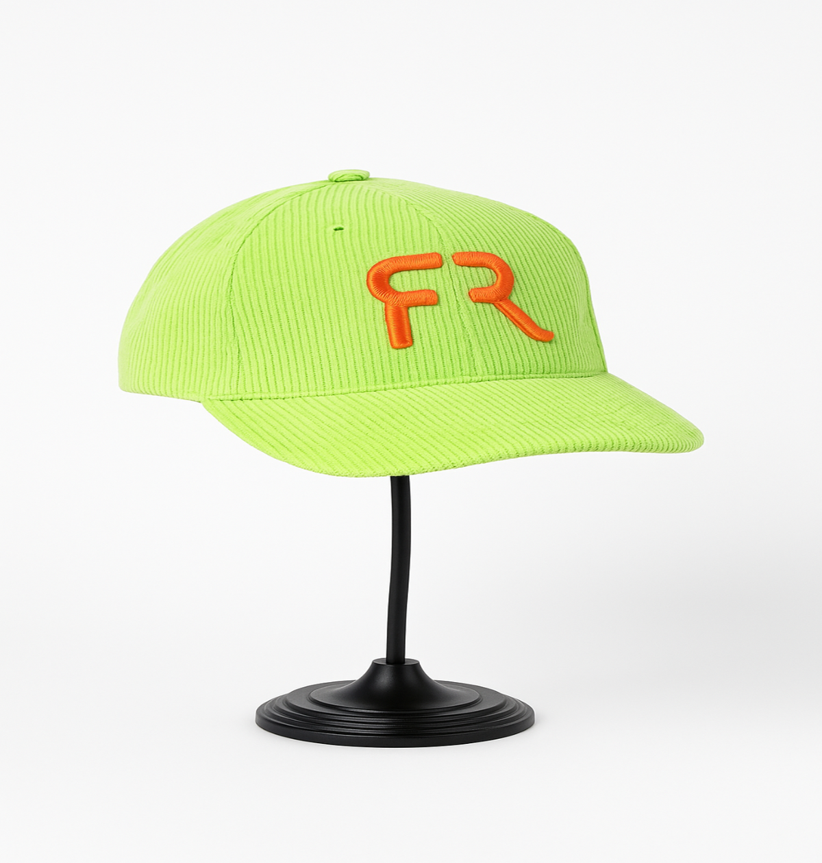 Neon green cap with orange 'FR' logo on a black stand against a white background